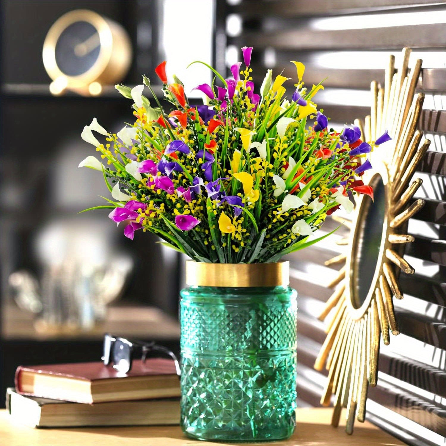 Colorful bouquet in a green textured vase on a table with decorative items in the background