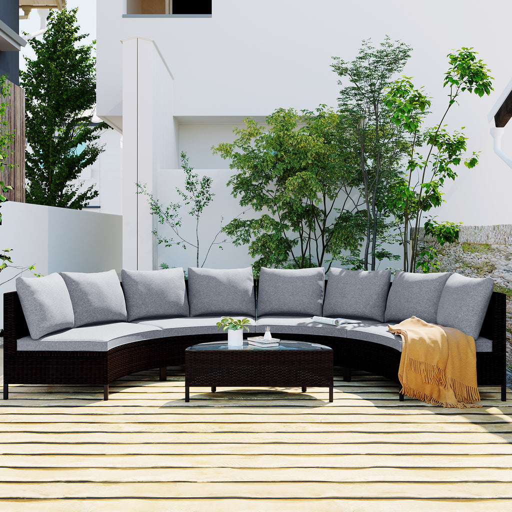 Outdoor patio set with gray cushions and a small table on a wooden deck.
