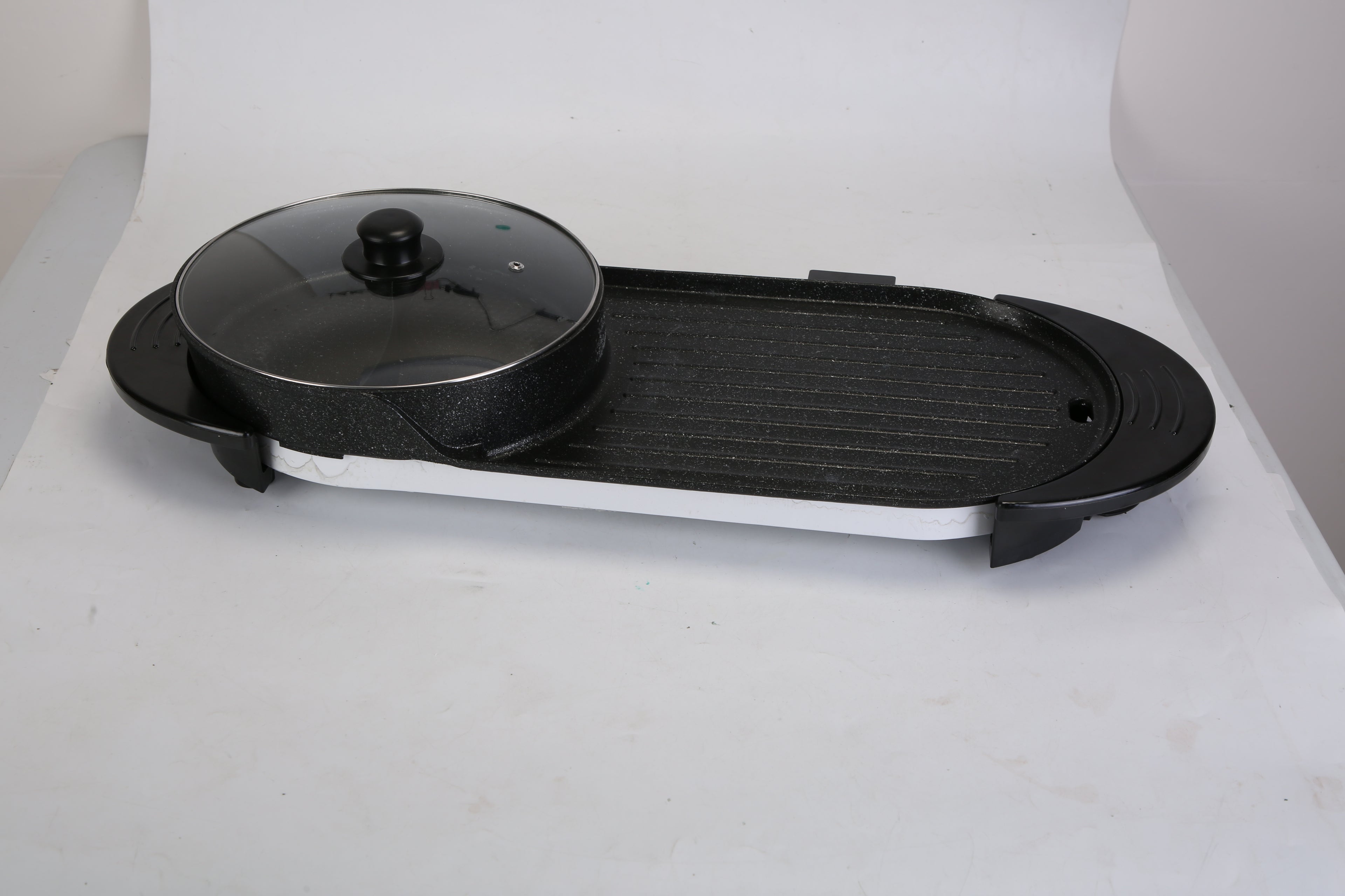 Black electric grill with lid on a white background