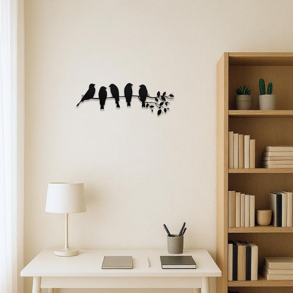 Modern home office with a desk, lamp, and wall art of birds on a branch.