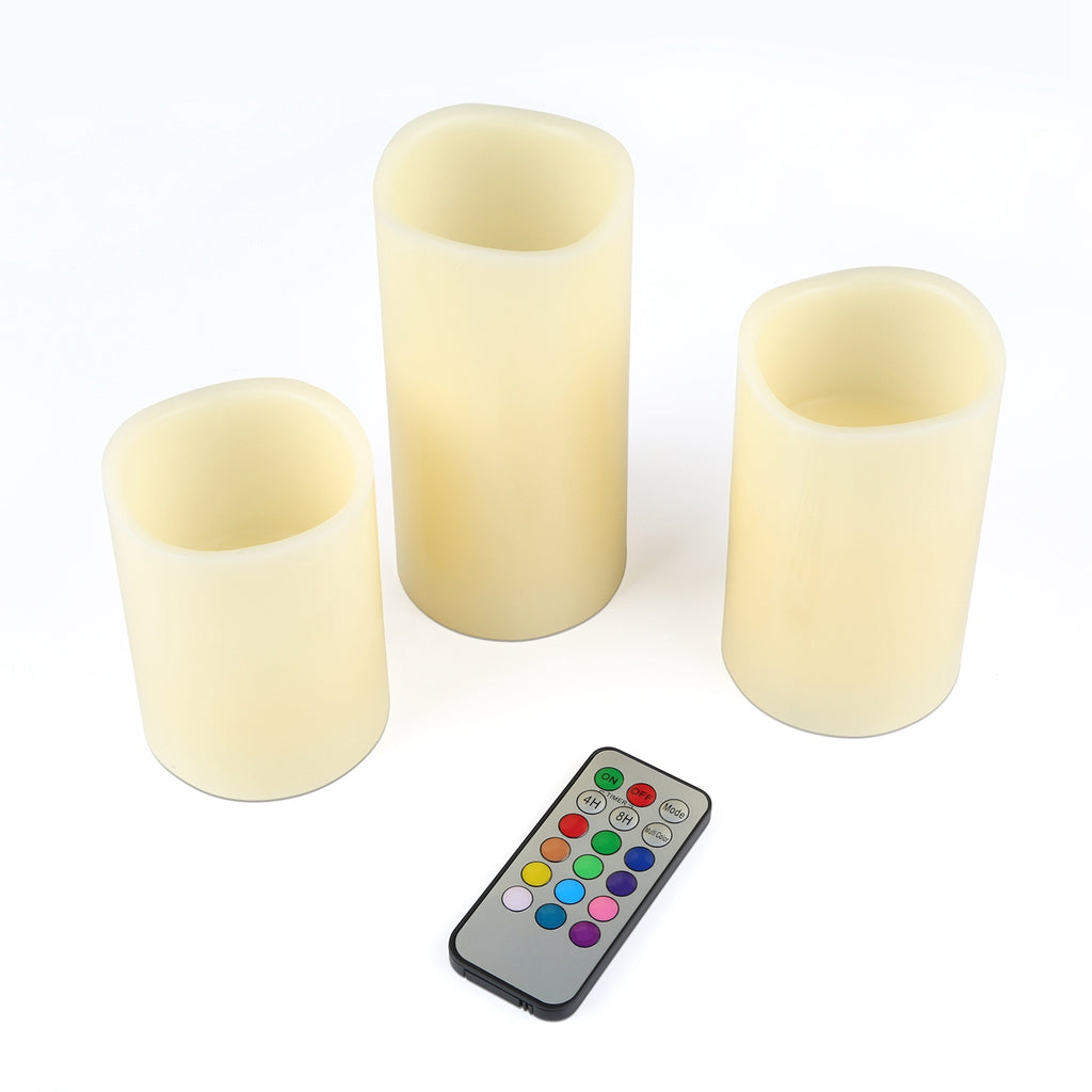 Three LED candles with a remote control on a white background