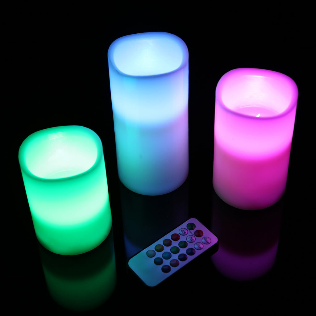 Three colorful LED candles with a remote control on a black background