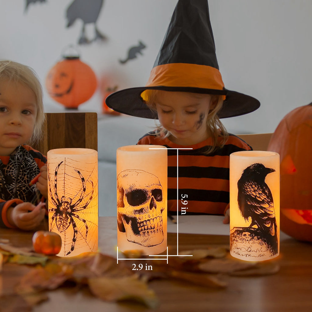 Child in Halloween costume with lit candles featuring spider, skull, and crow designs.