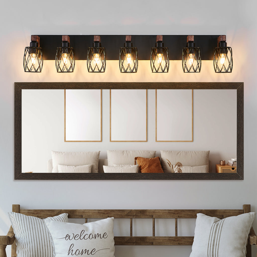 Wall mirror with decorative lights above a sofa in a living room setting.