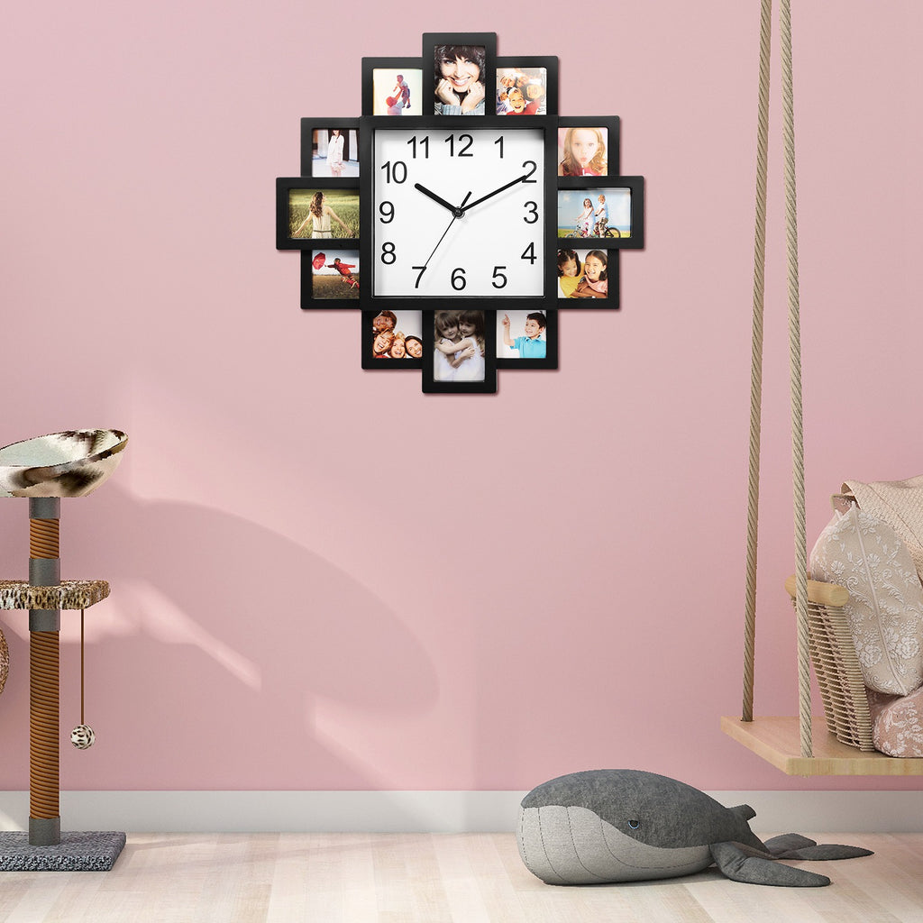 Wall clock with photo frames on a pink wall, surrounded by children's toys.