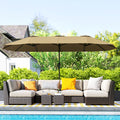 Outdoor patio set with a large umbrella by a poolside