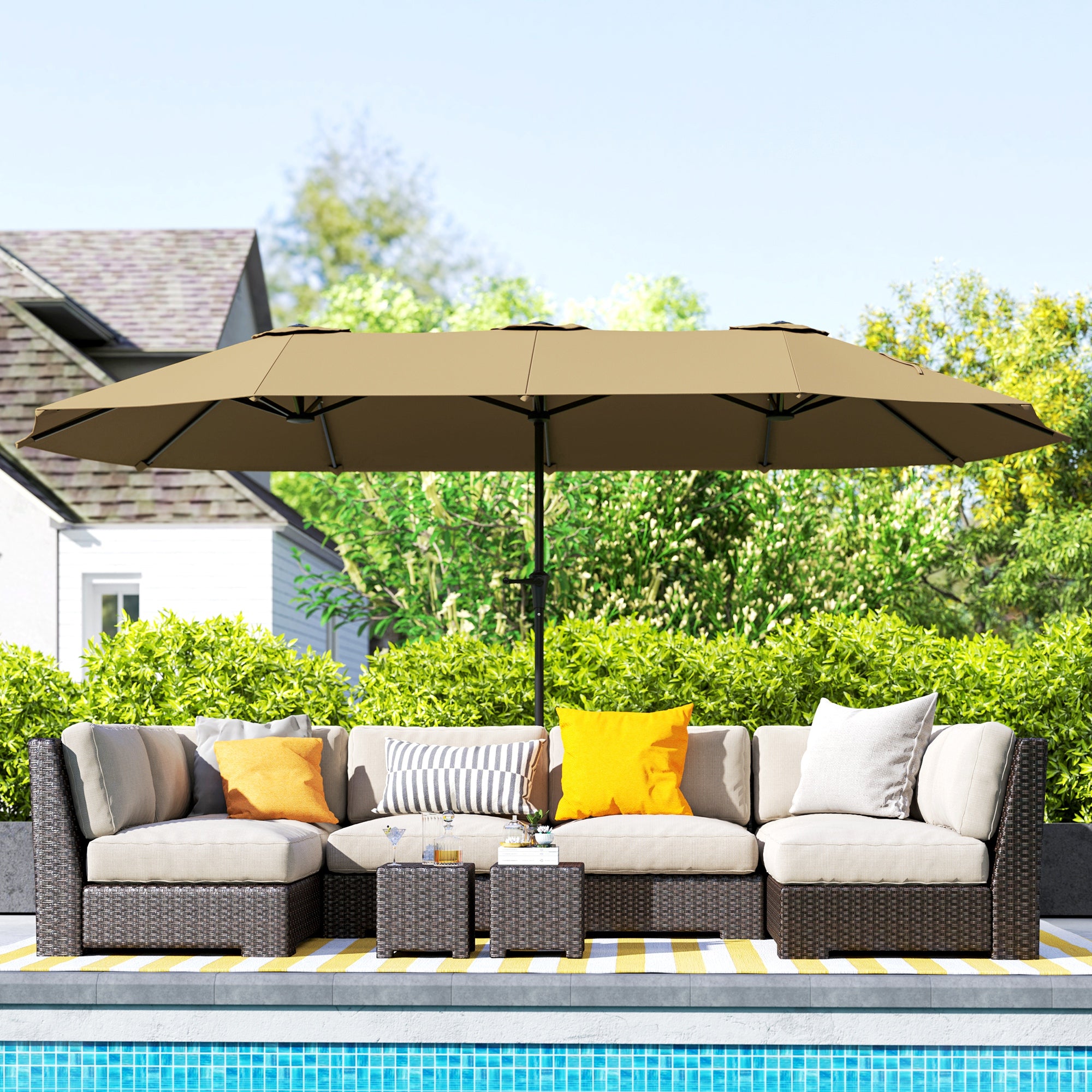Outdoor patio set with a large umbrella by a poolside
