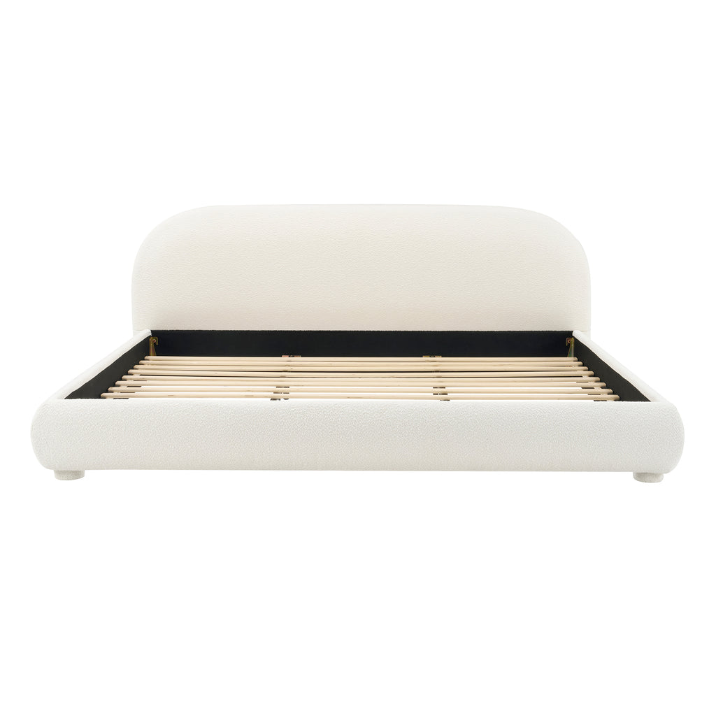 White upholstered bed with gold frame on a white background