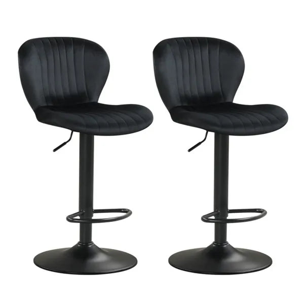 Two black swivel bar stools with cushioned seats positioned at a modern kitchen island with wood cabinetry