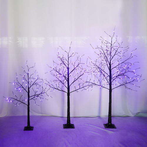 Three LED tree lights with purple and white lights on a white background