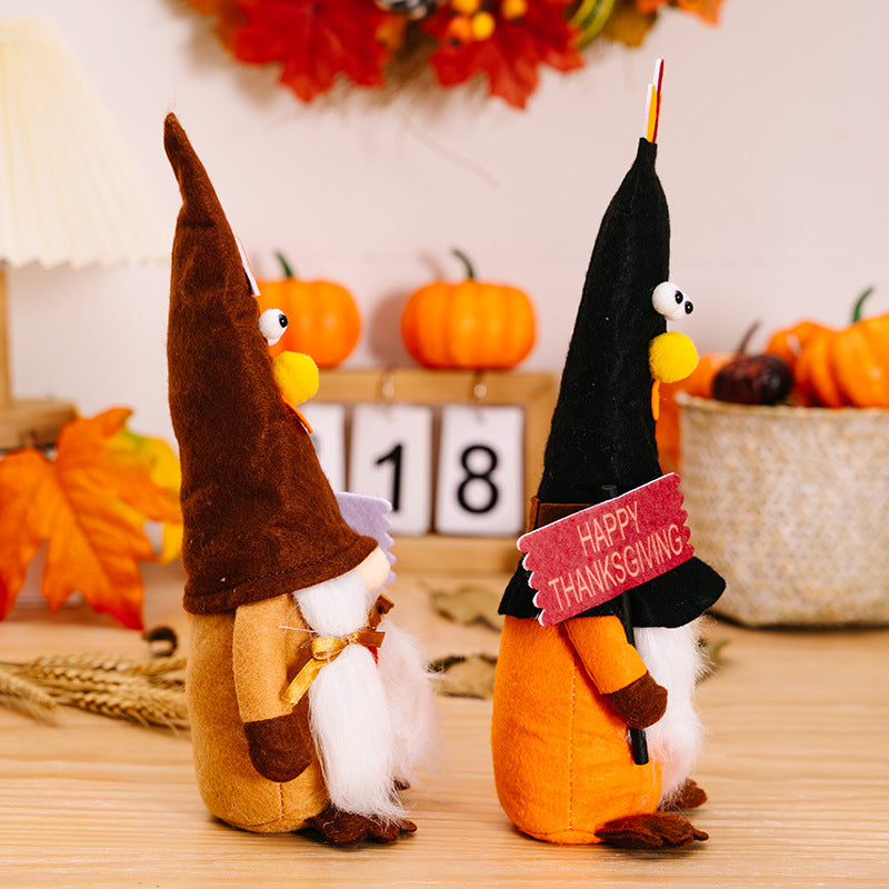 Two decorative figures, one resembling a gnome and the other a witch, with pumpkins and autumn decorations in the background.