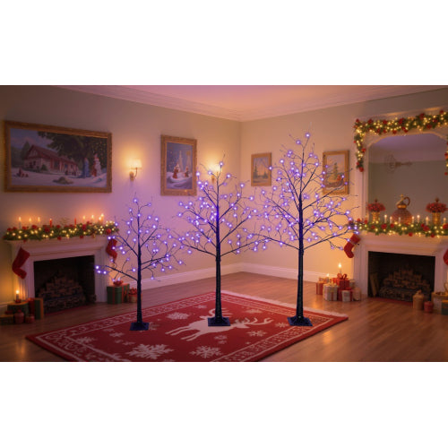 Decorative LED trees in a living room with festive decorations.