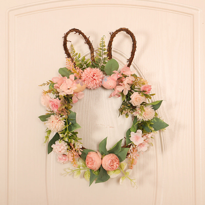 Floral wreath with bunny ears on a white door