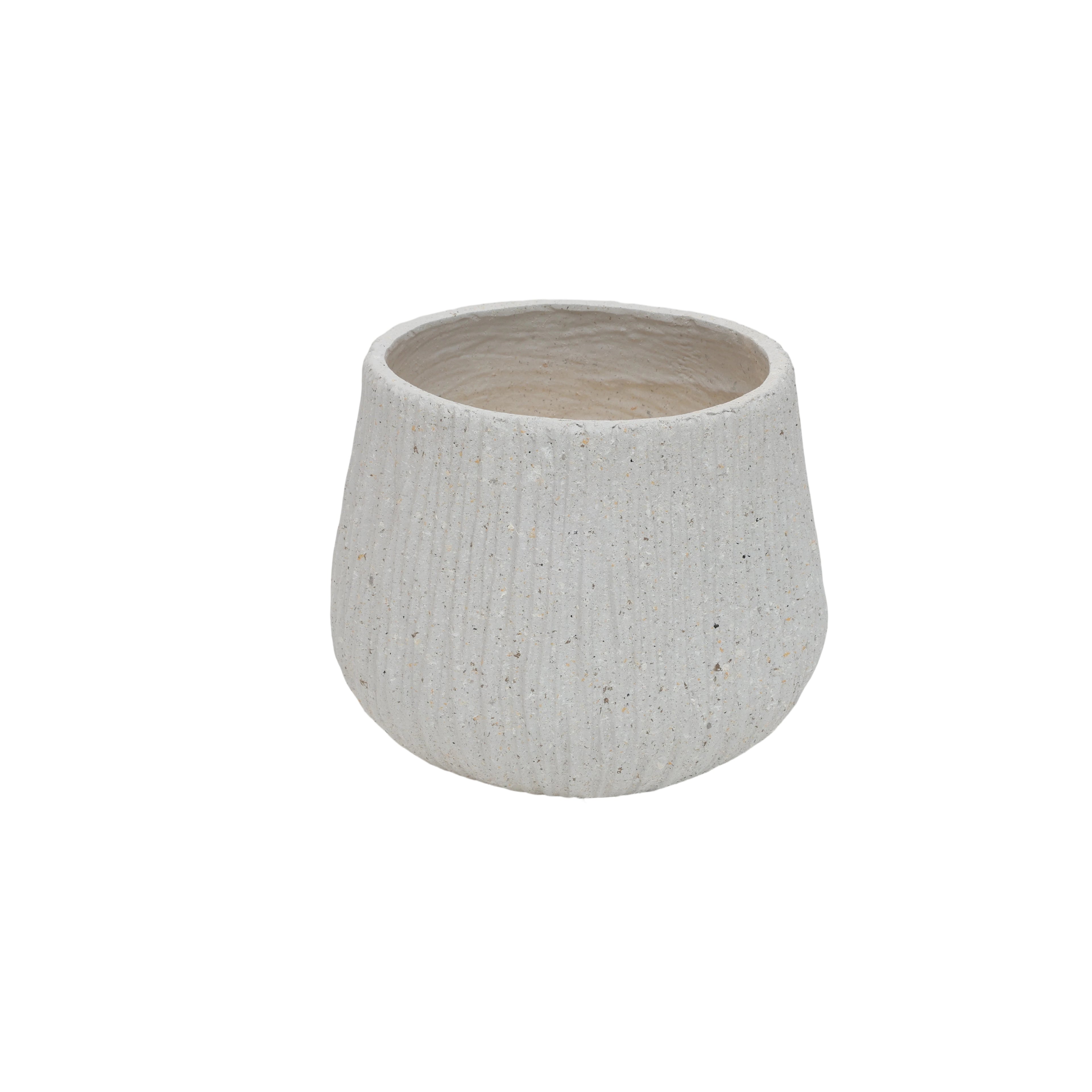 Textured ceramic pot on a white background