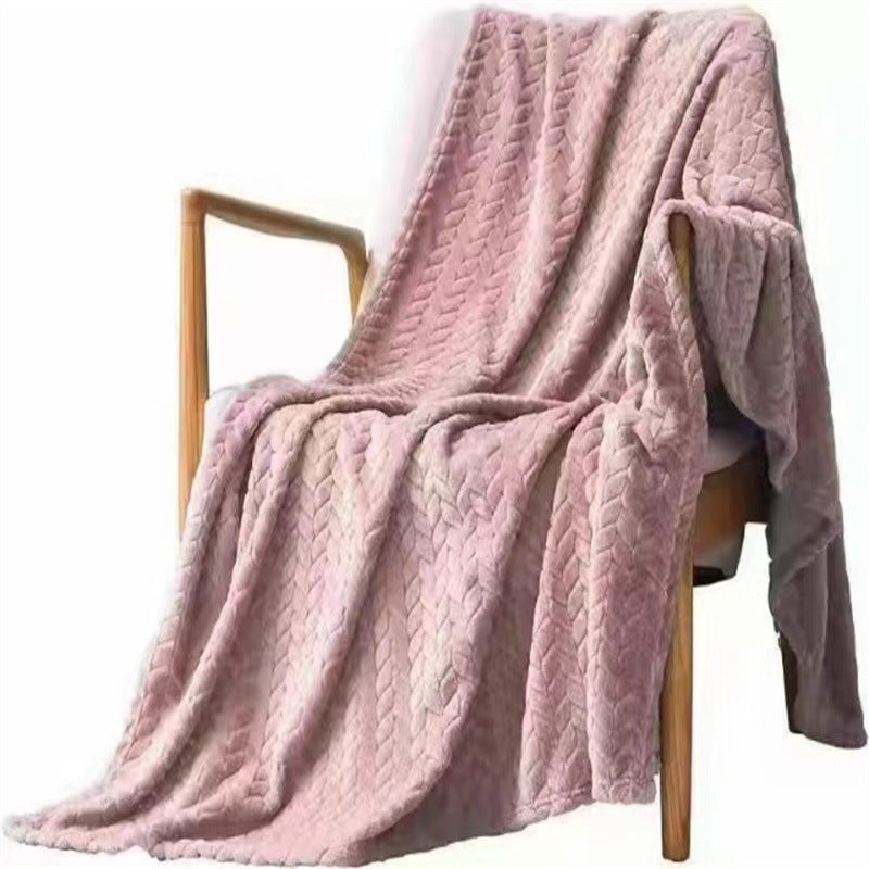 Pink textured blanket draped over a wooden chair on a white background