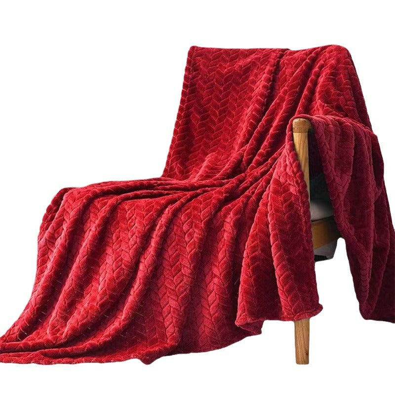 Red textured blanket draped over a wooden chair on a white background
