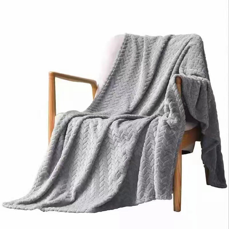 Gray textured blanket draped over a wooden chair on a white background