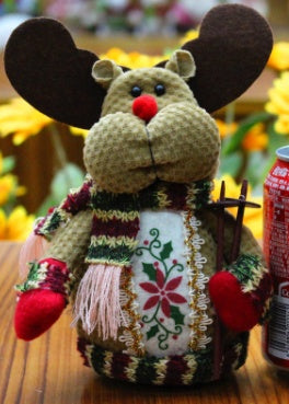 Decorative mouse figurine with a patterned scarf on a wooden surface