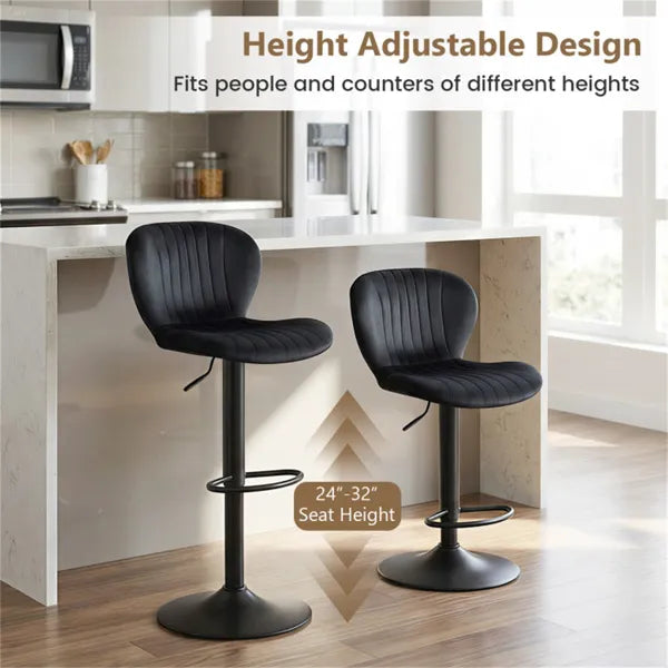 Two black swivel bar stools with cushioned seats positioned at a modern kitchen island with wood cabinetry