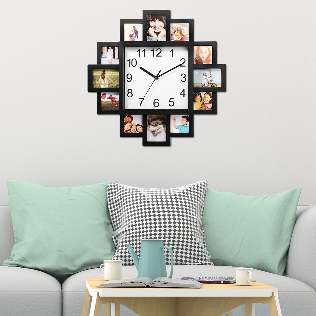 Wall clock with photo frames on a wall above a sofa with cushions.