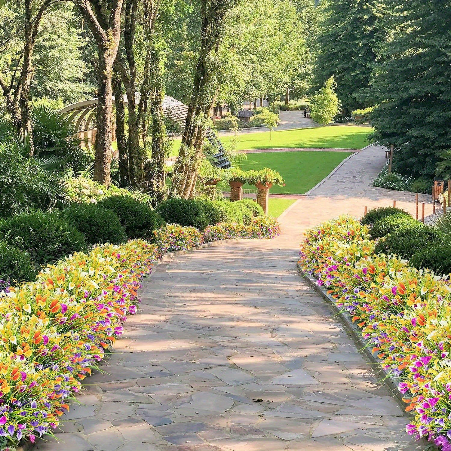Stone pathway lined with colorful flowers in a park setting