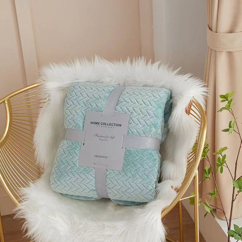 Folded quilt with a label on a fluffy chair in a cozy room.