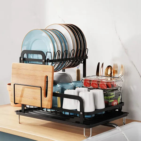 Black dish rack with various dishes on a kitchen counter