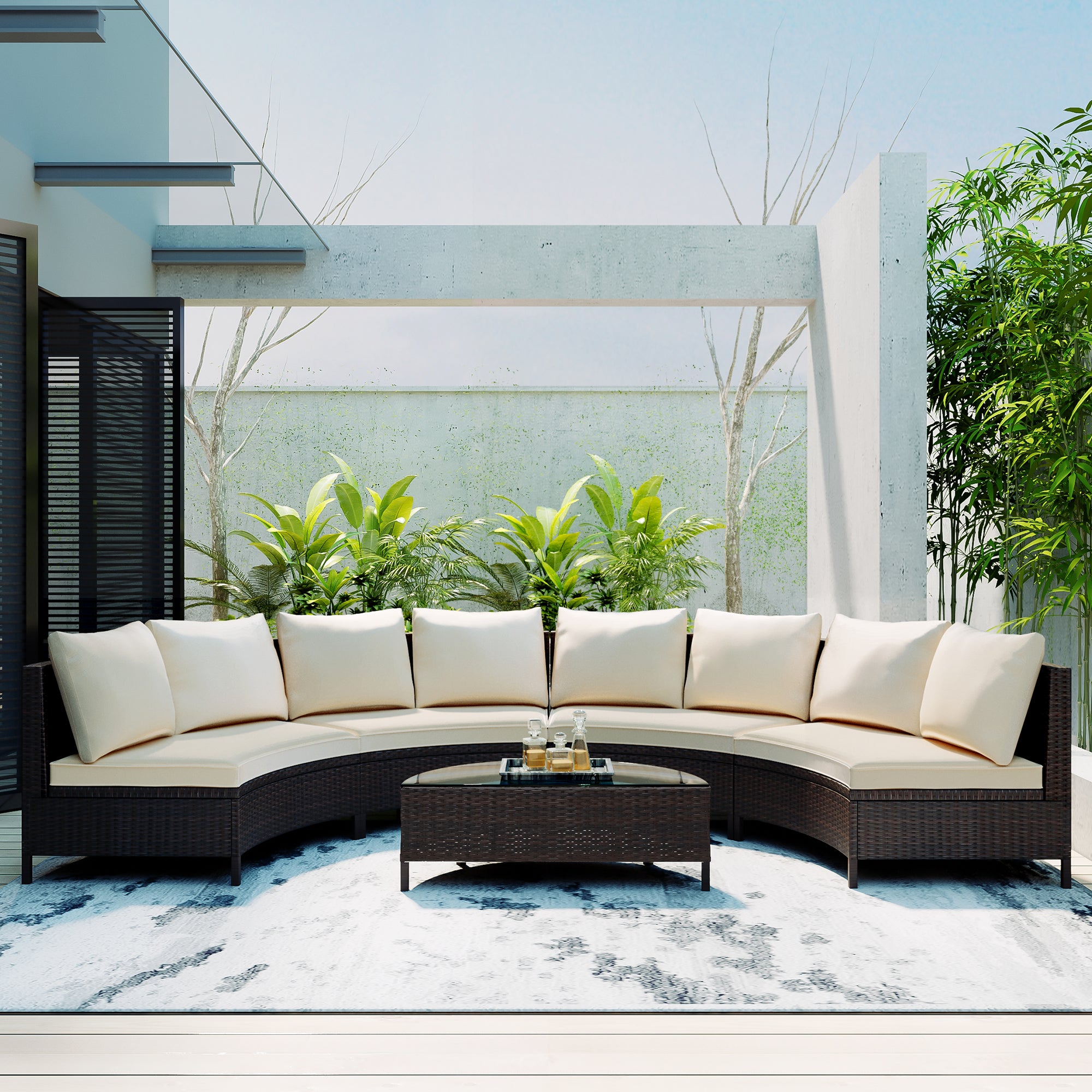 Outdoor patio set with curved sofa and coffee table in a modern garden setting.