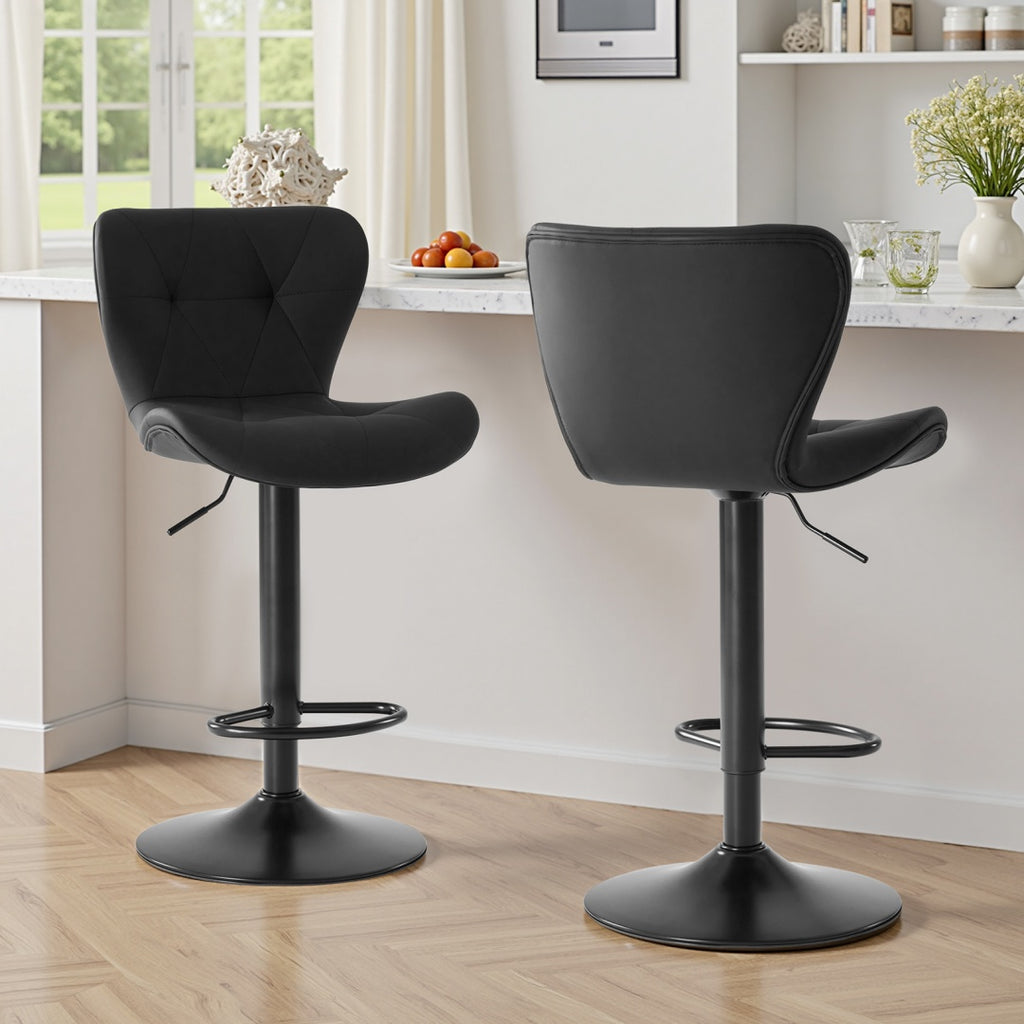 Two swivel bar stools with cushioned seats positioned at a modern kitchen island with wood cabinetry