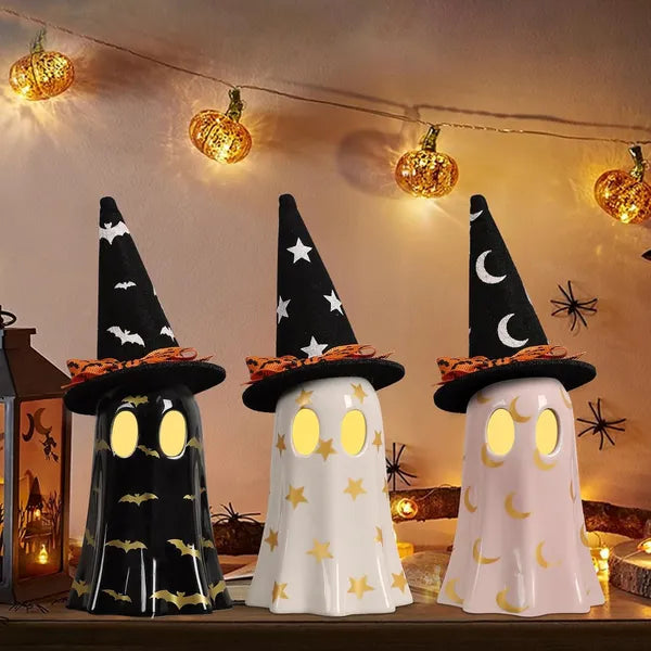 Three Halloween-themed ghost lights with witch hats on a decorative setup.