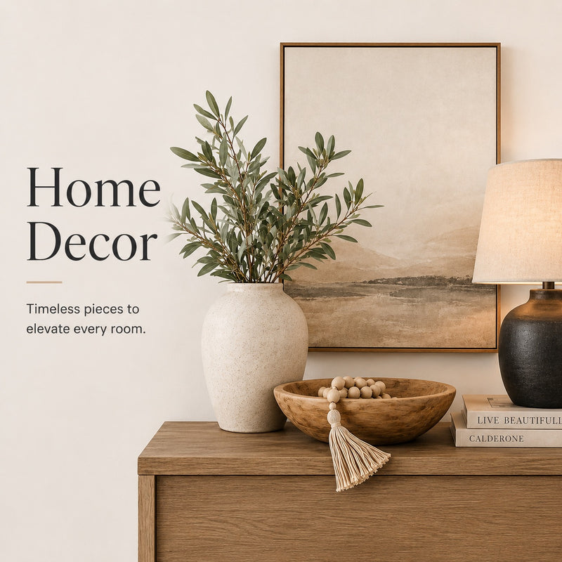 Home decor items including a vase with plants, a bowl, a lamp, and books on a wooden surface.