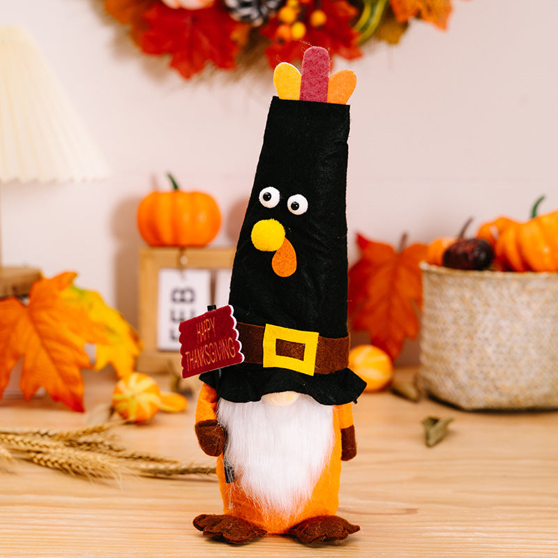 Thanksgiving-themed gnome with black shirt and orange pants on a wooden surface with pumpkins and leaves.