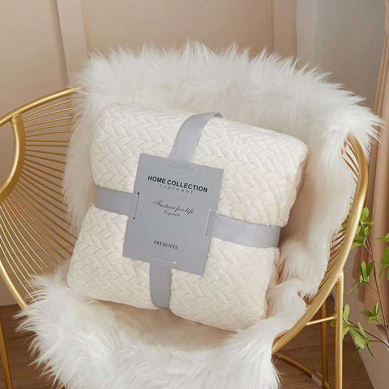 White quilt with a visible brand tag on a gold chair