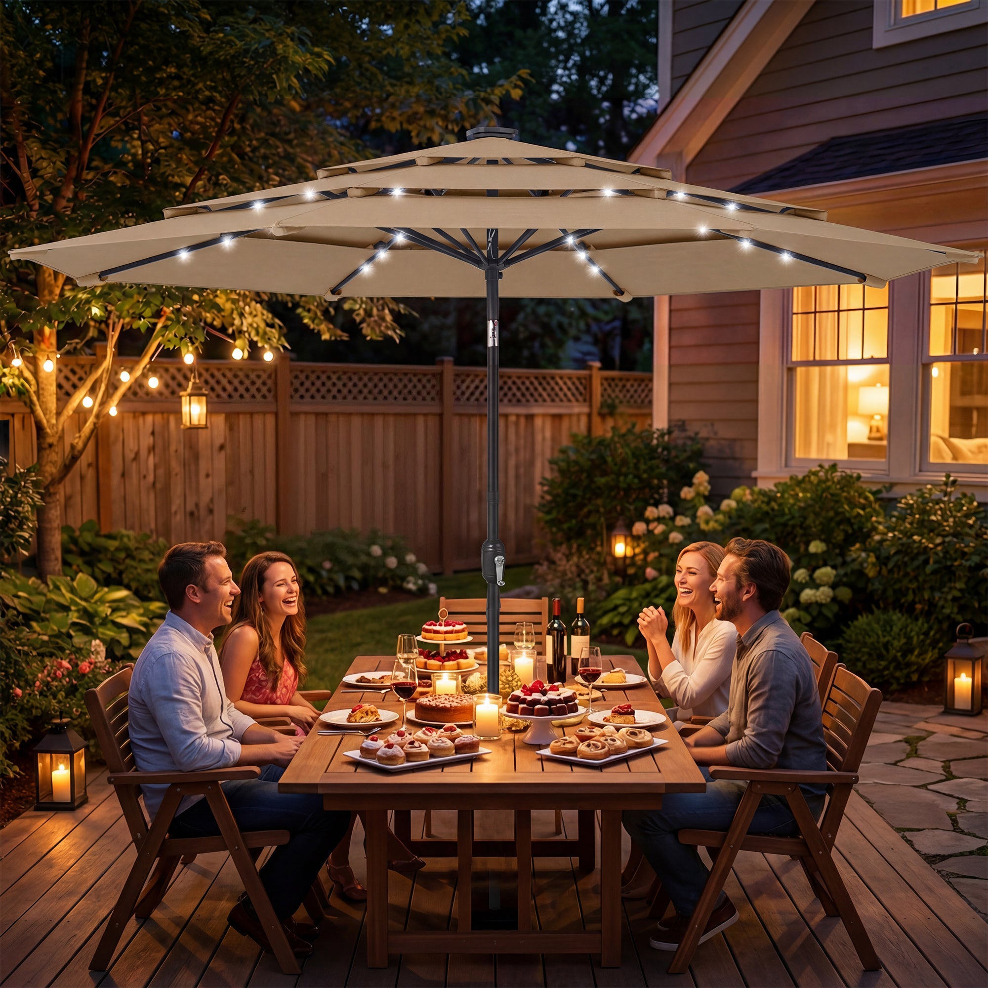 People enjoying a dinner party outdoors under a large patio umbrella with string lights.