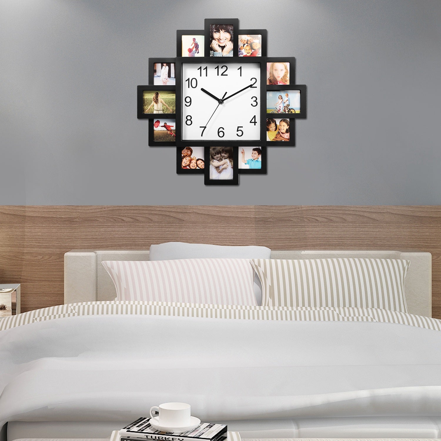 Wall clock with photo frames displaying family photos above a bed in a bedroom.