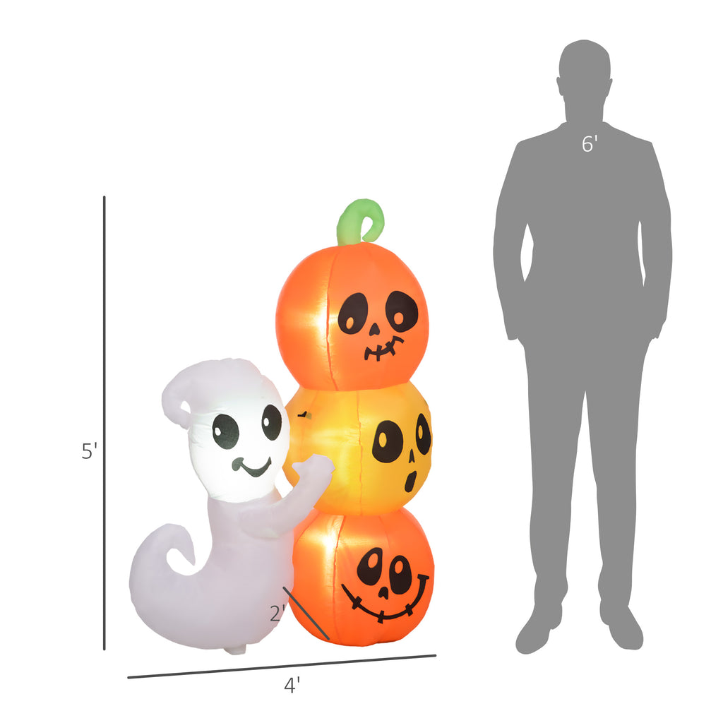 Halloween inflatable decorations including a ghost and pumpkins with a person's silhouette for scale.