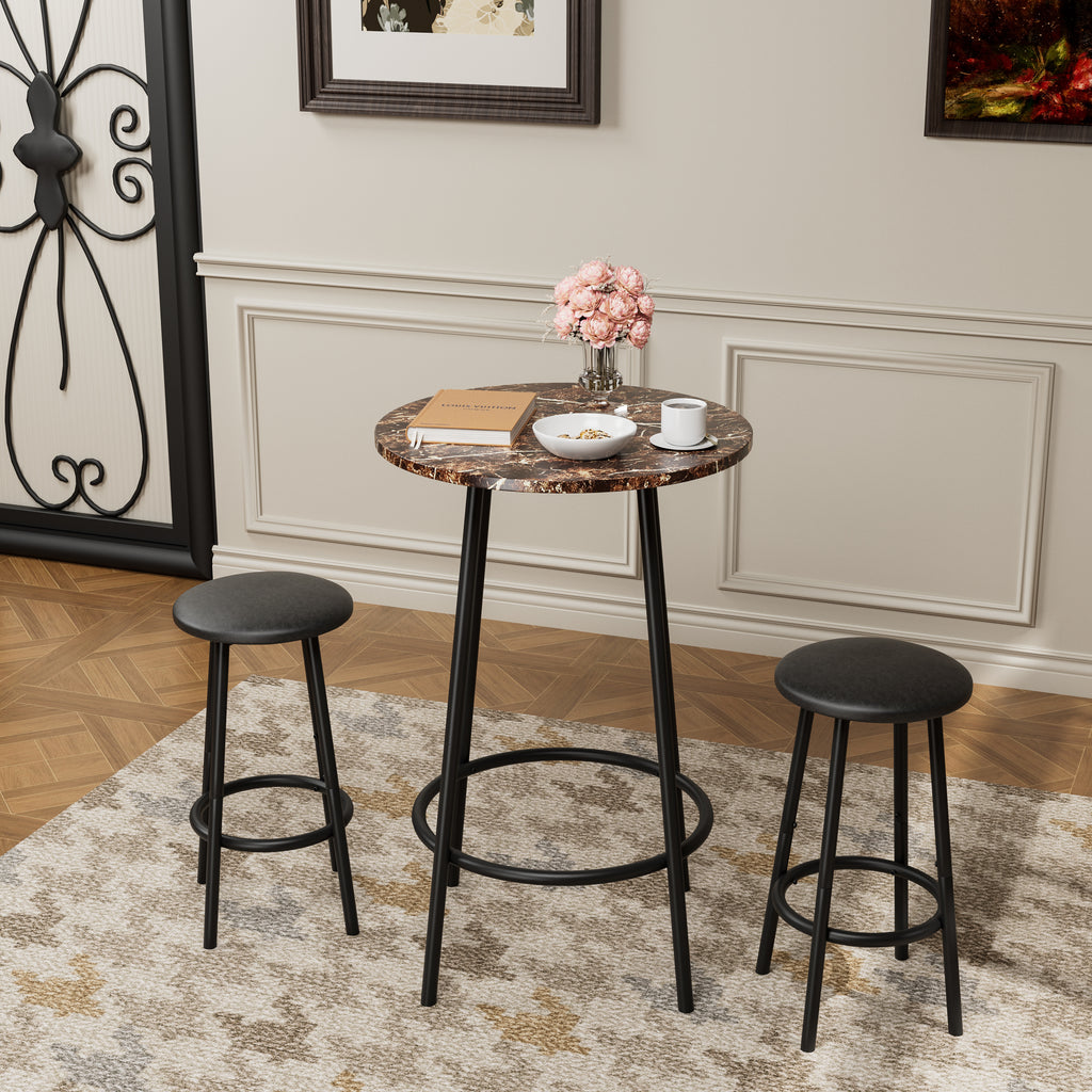 3-piece counter-height pub set with marble-look round table and two black cushioned stools in a bright living space