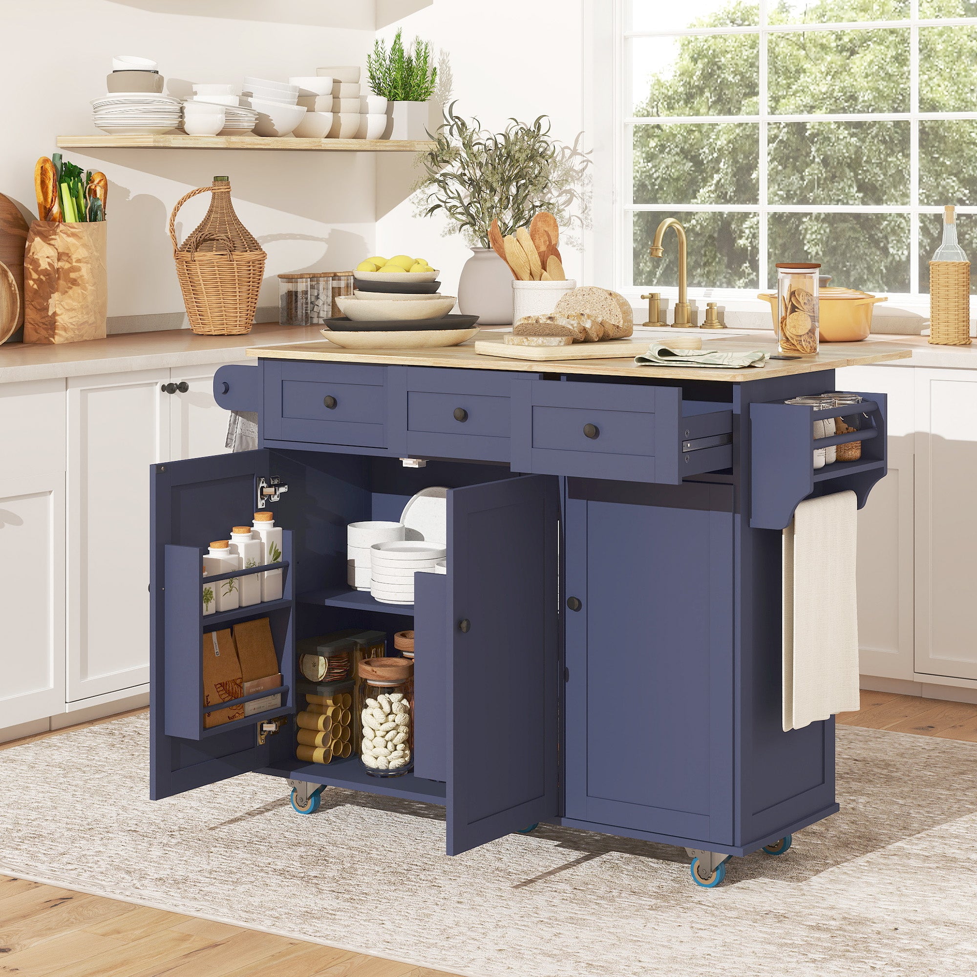 Blue kitchen island with open doors in a bright kitchen