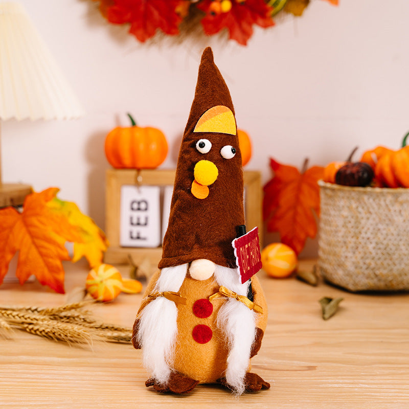 Decorative turkey gnome with a sign in a festive setting with pumpkins and leaves.