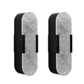 Two cylindrical wall lights with marble-like finish and black accents on a white background
