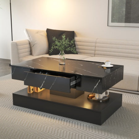 Modern black coffee table with marble-like finish in a living room setting.