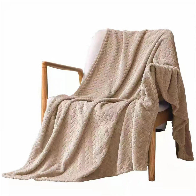Beige textured blanket draped over a wooden chair on a white background