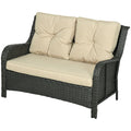 Wicker outdoor loveseat with beige cushions on a white background