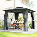 People sitting at a table under a black outdoor gazebo with curtains on a patio.