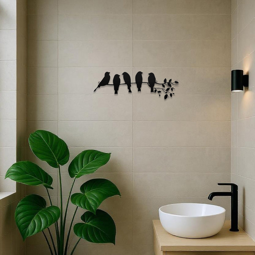 Modern bathroom with a sink, towel, plant, and decorative wall art.