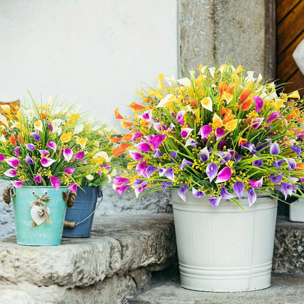 Colorful artificial flowers in metal buckets on a stone surface.