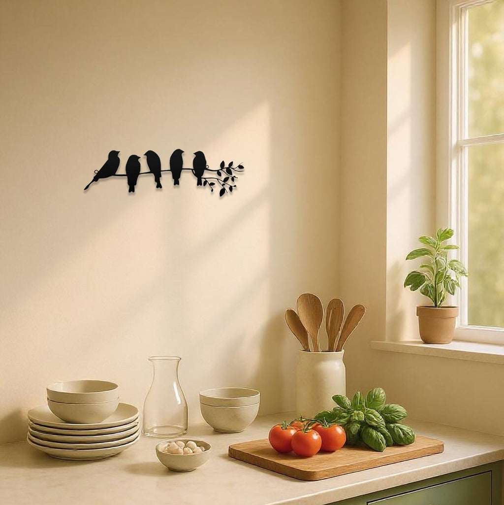 Kitchen counter with green cabinets, wooden cutting board with fruits and vegetables, and decorative wall art.