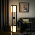 Living room with a floor lamp, sofa, and wall art